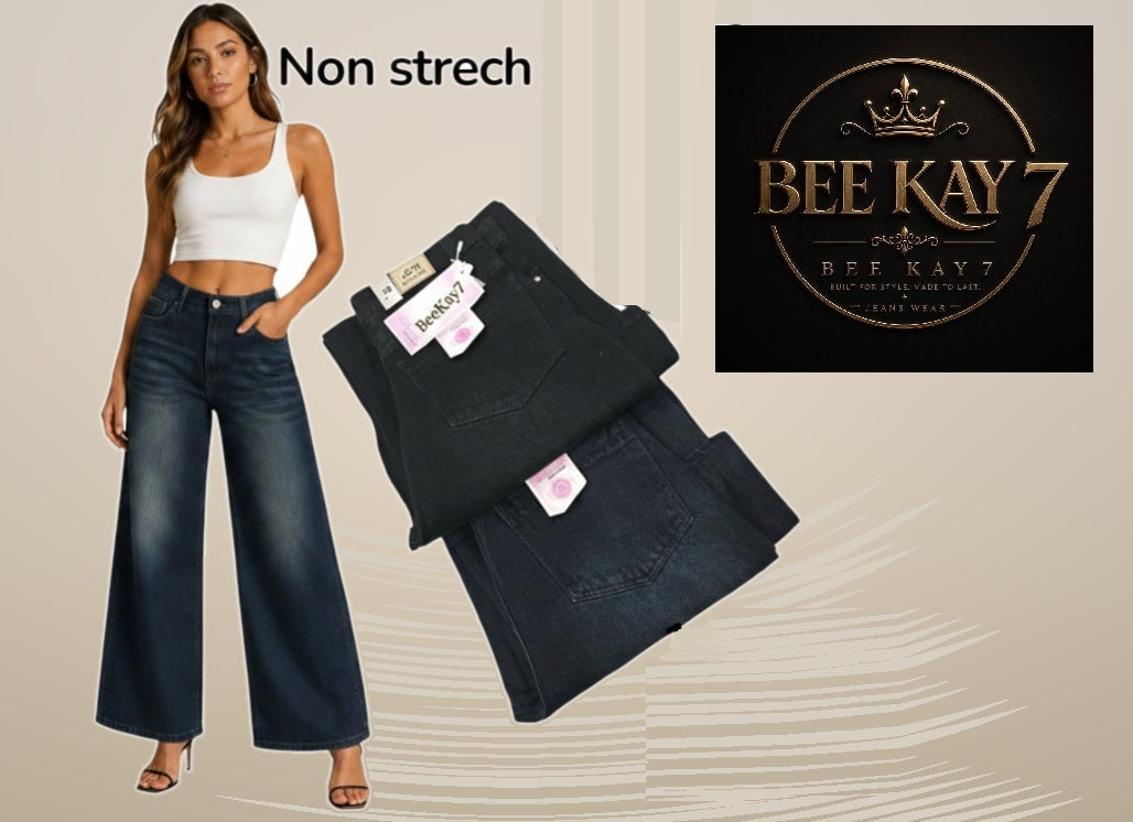 A model wears dark blue non-stretch wide-leg jeans on the left, with folded pairs of the same jeans shown on the right. A black square logo at top right reads BEE KAY 7.
